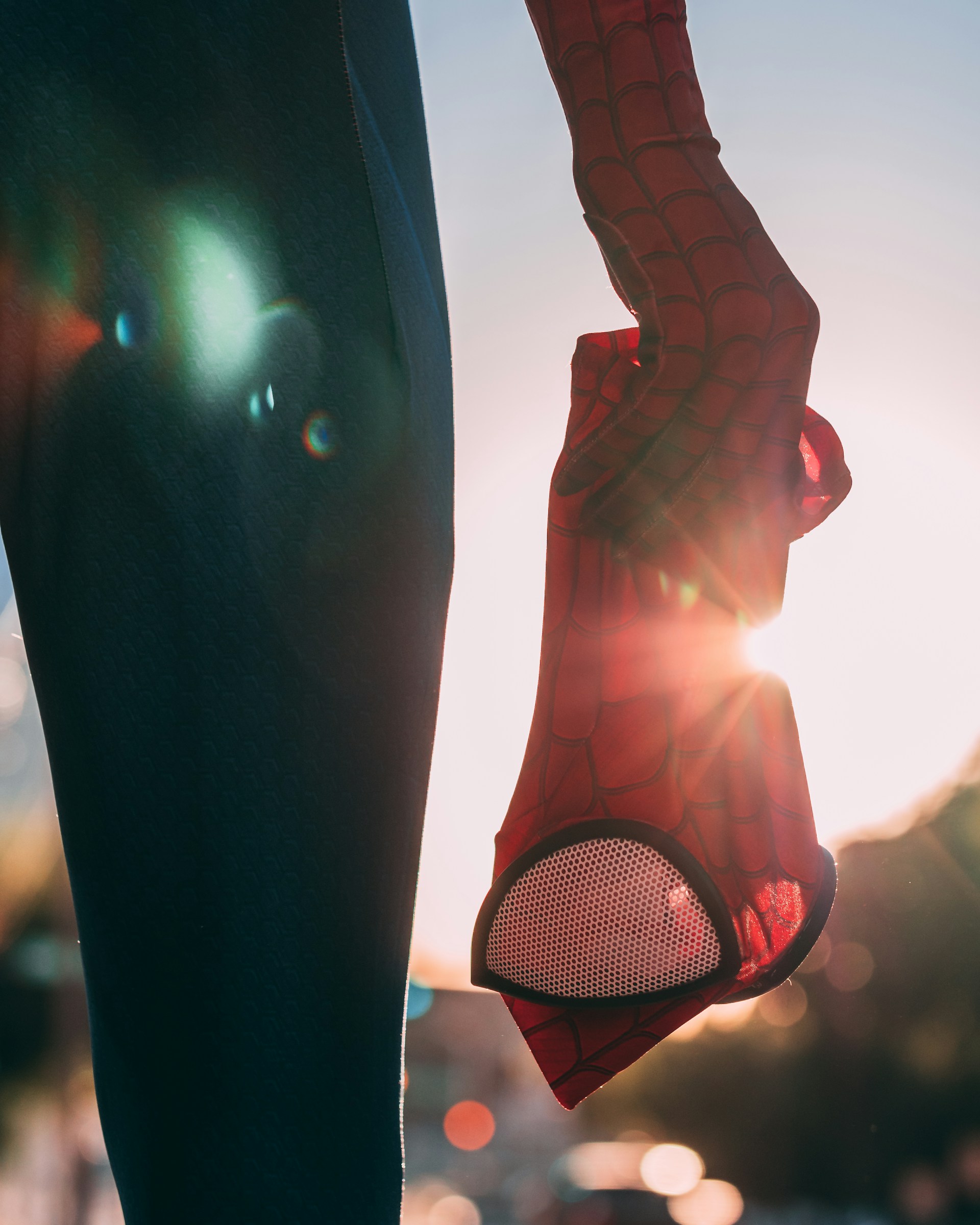 Spider-Man standing with his mask held down by his side