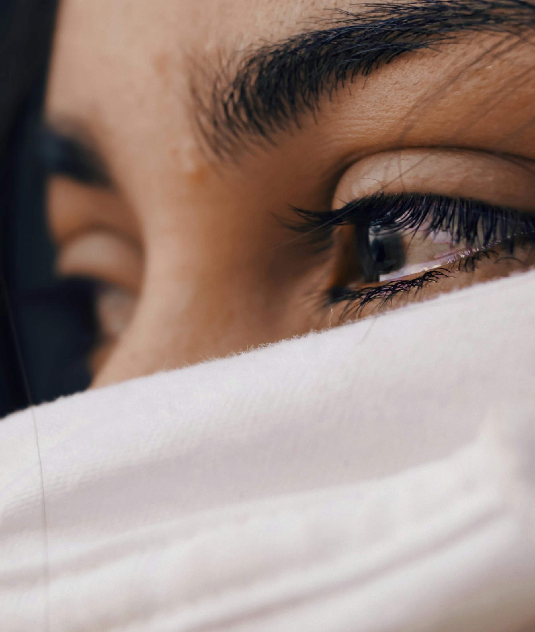 Close-up of a woman’s face with tears flooding her eyes, conveying intense vulnerability and heartfelt emotion as a TikTok reaction image